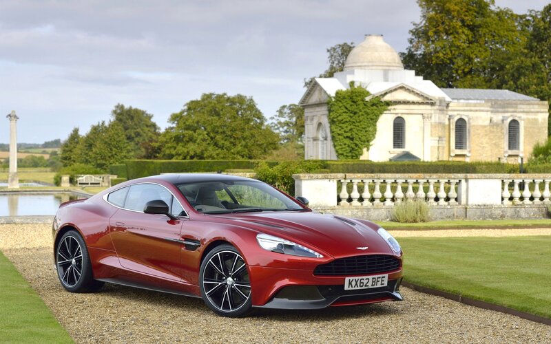 Red Aston Martin in a garden
