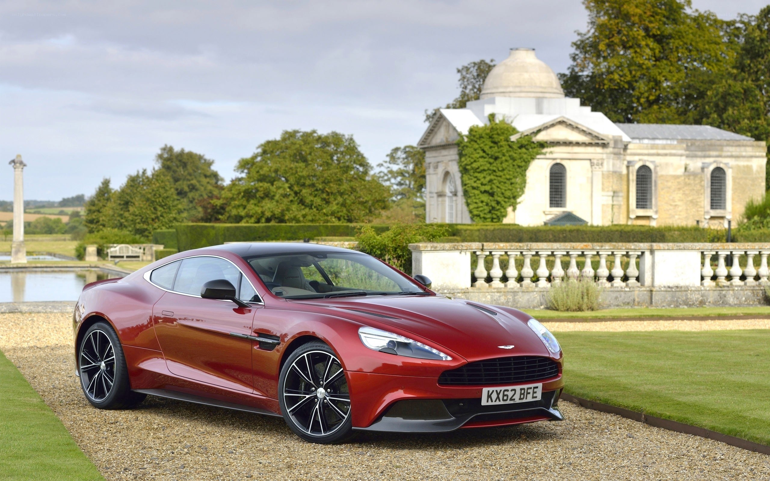 Red Aston Martin in a garden