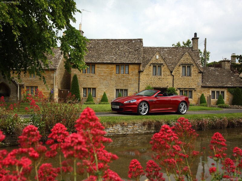 Red Aston Martin in a village