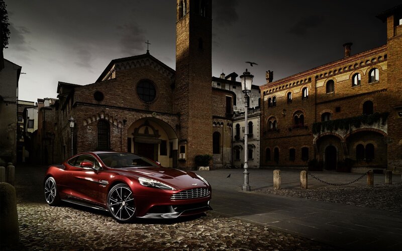 Red Aston Martin in historic square