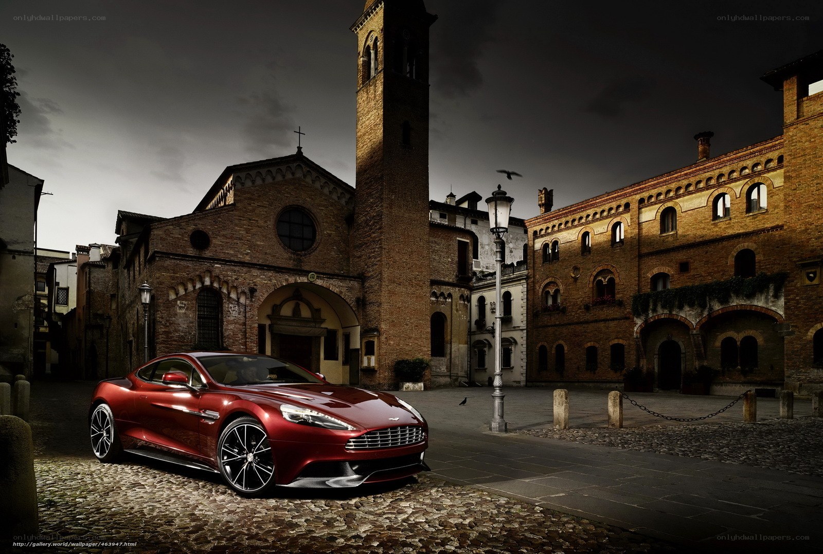 Red Aston Martin in historic square
