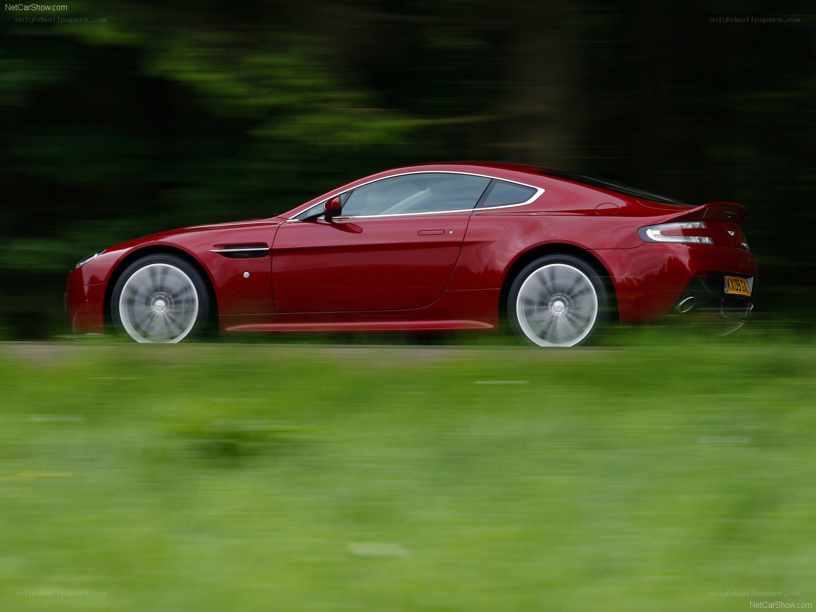 red aston martin in motion