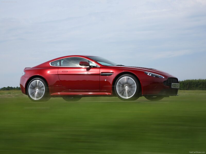 red aston martin in motion