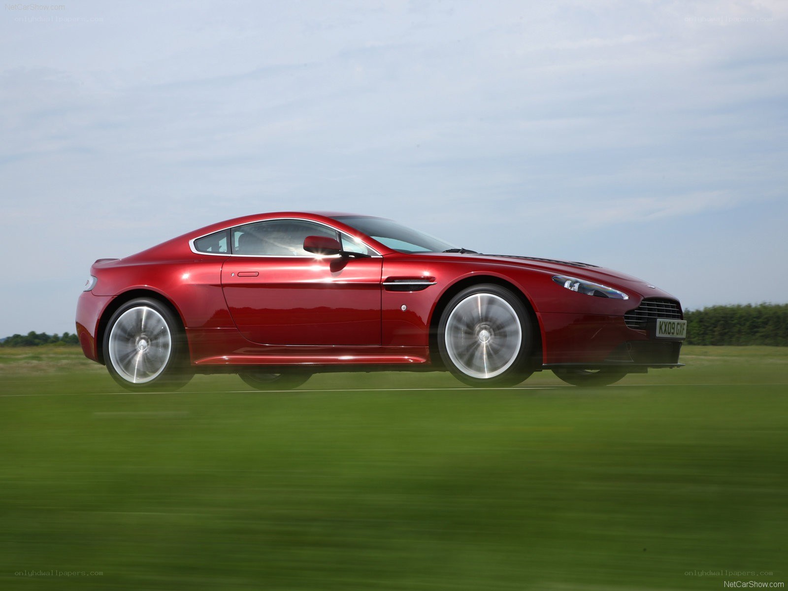 red aston martin in motion