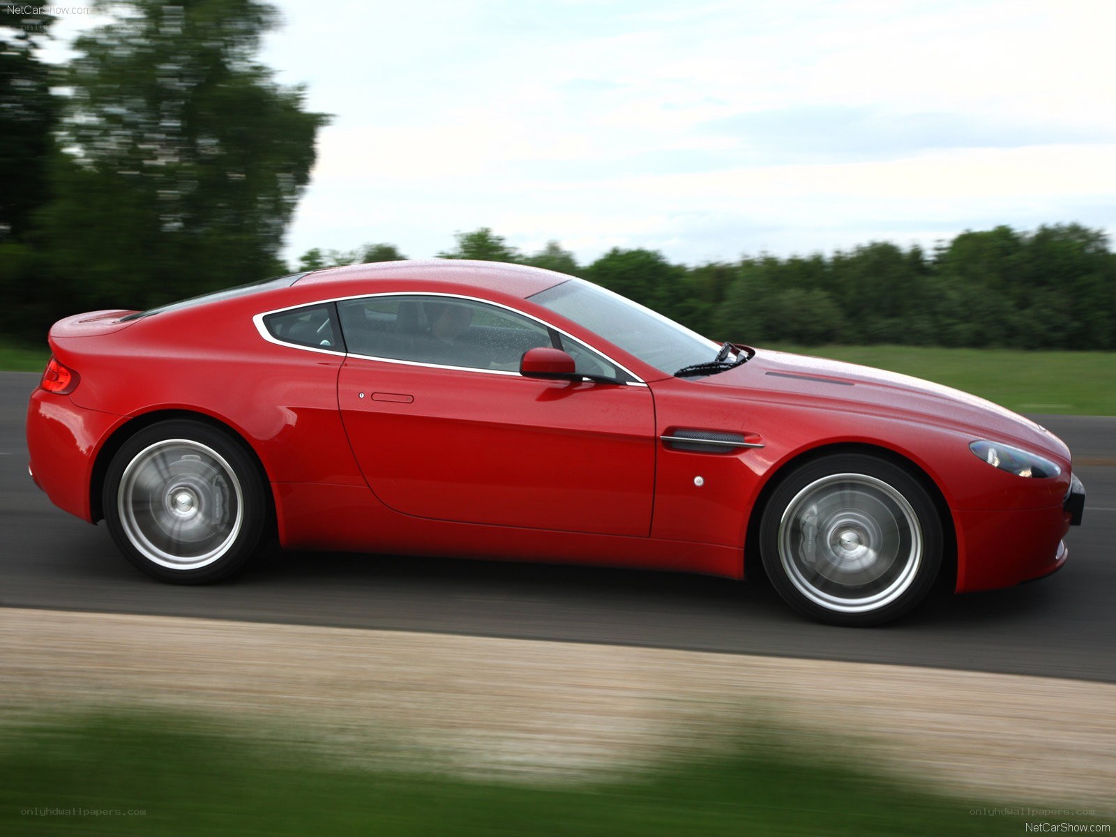 red aston martin in motion