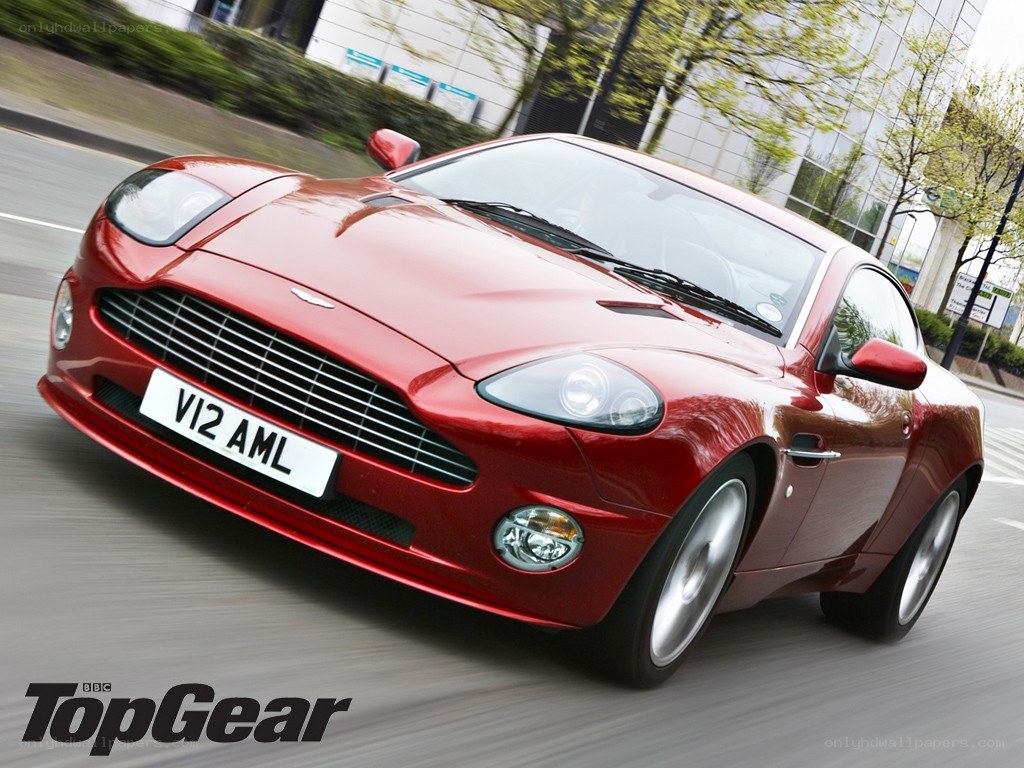 red aston martin in motion
