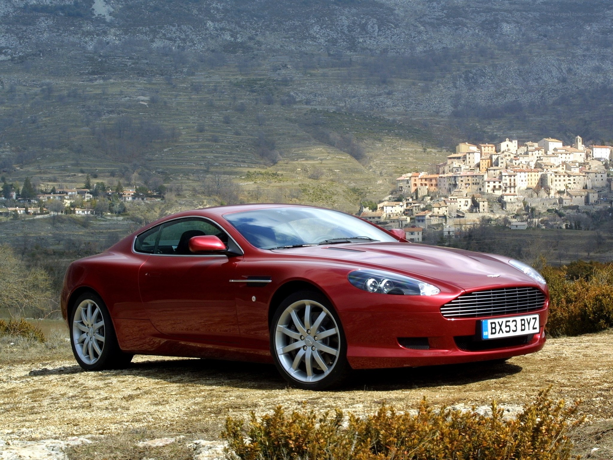 Red Aston Martin in mountain landscape