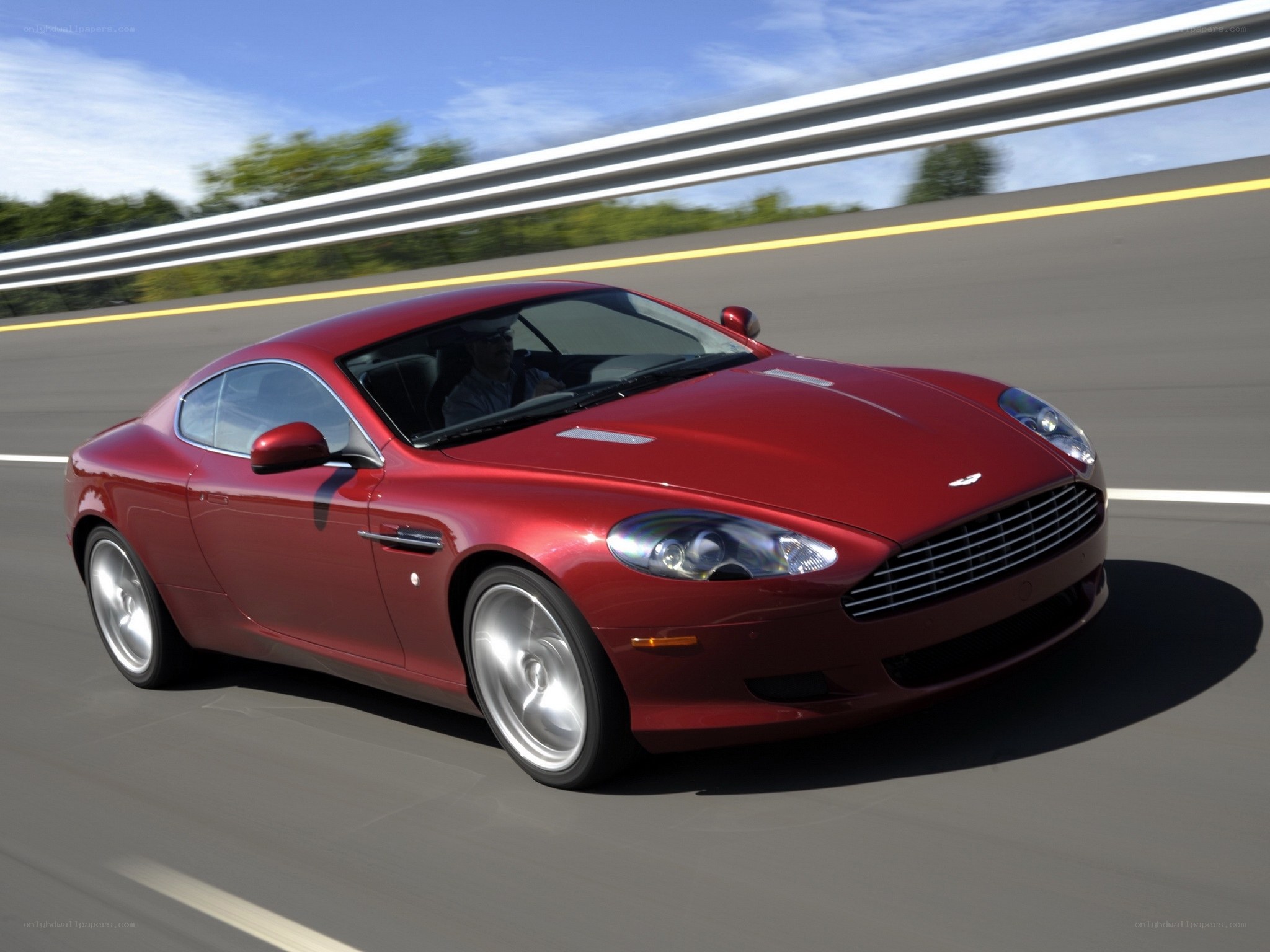 Red Aston Martin on a highway
