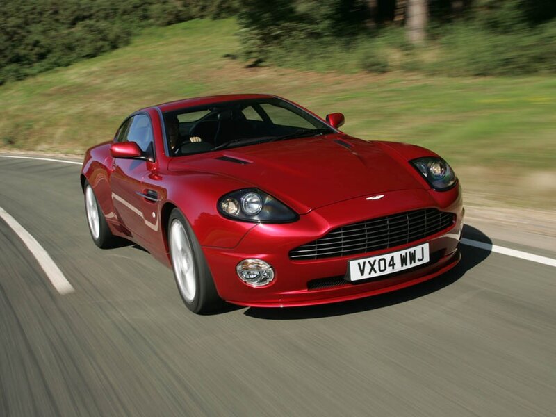 Red Aston Martin on a road