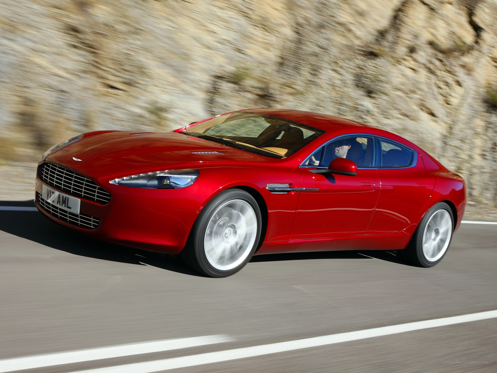 Red Aston Martin on a road
