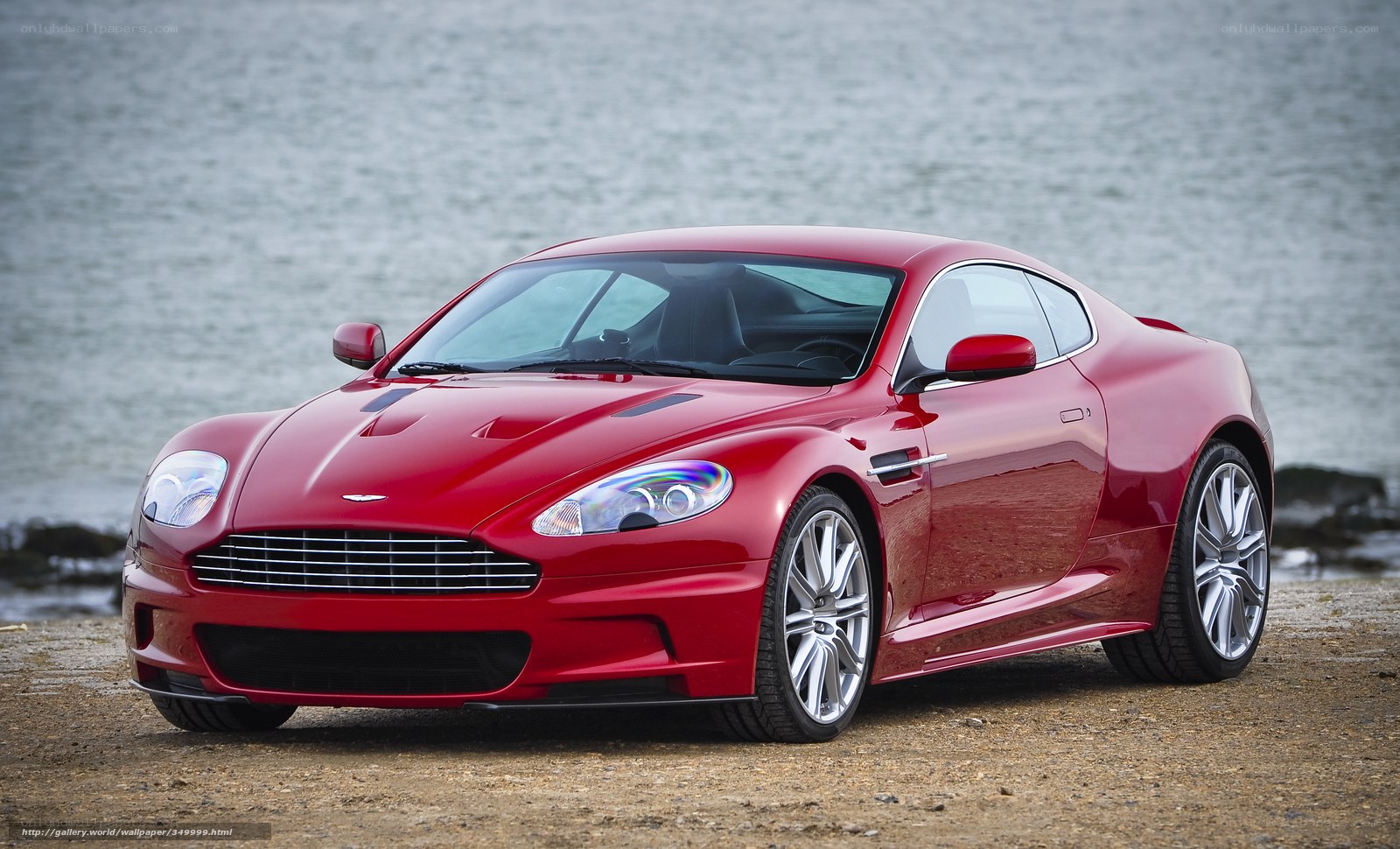 Red Aston Martin on beach