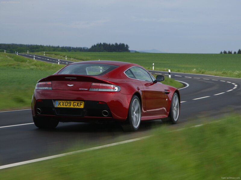 red aston martin on country road