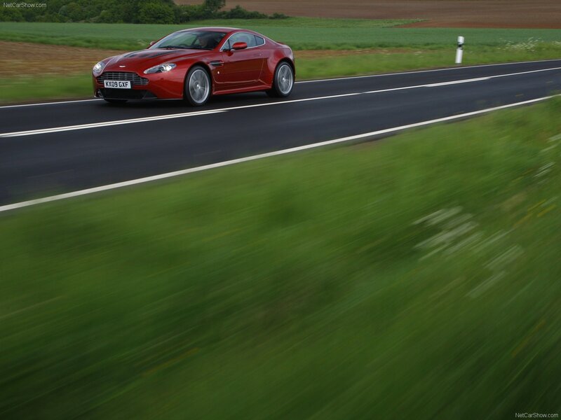 Red Aston Martin on country road