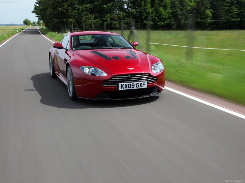 Red Aston Martin on country road