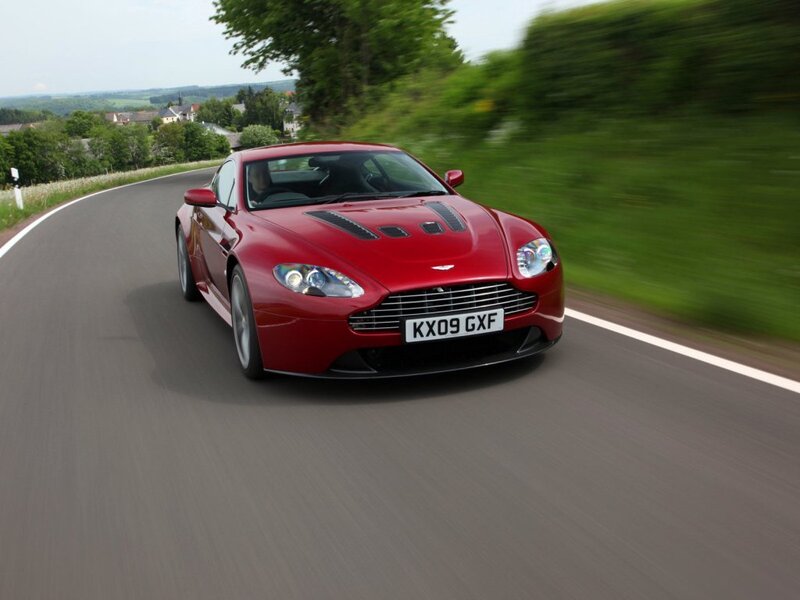 Red Aston Martin on country road