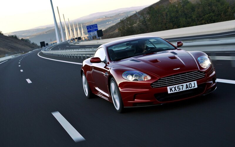 Red Aston Martin on highway