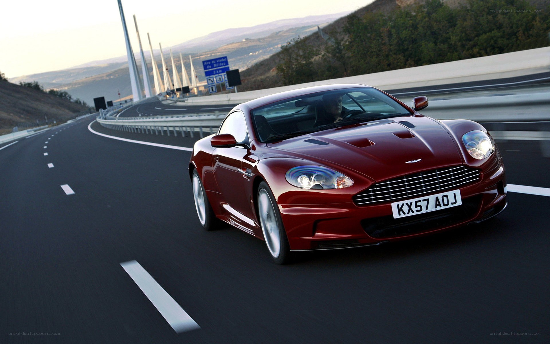 Red Aston Martin on highway