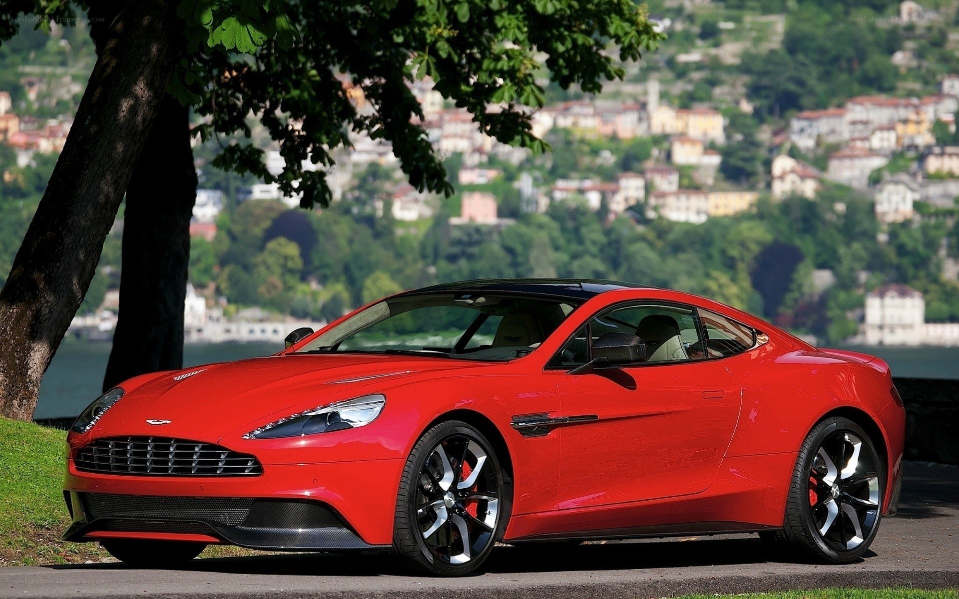 Red Aston Martin on lakeside