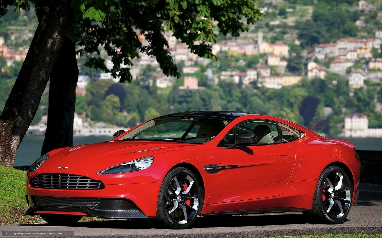 Red Aston Martin on lakeside