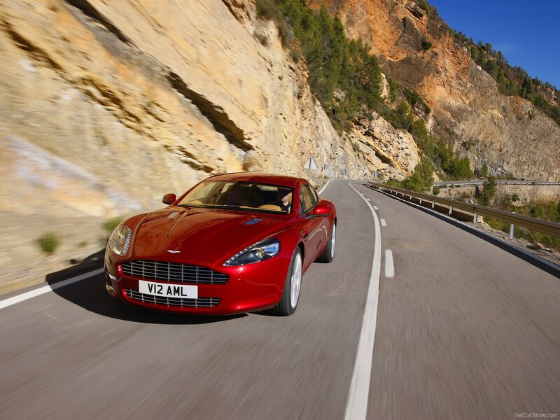 Red Aston Martin on mountain road