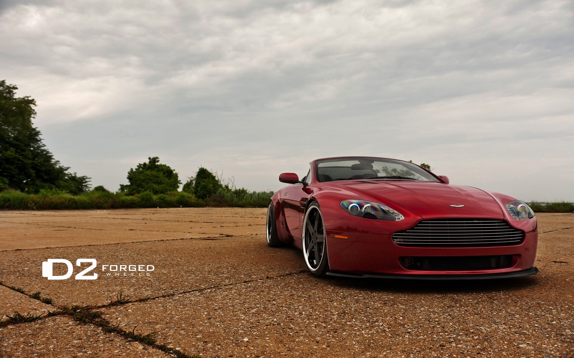 Red Aston Martin on pavement