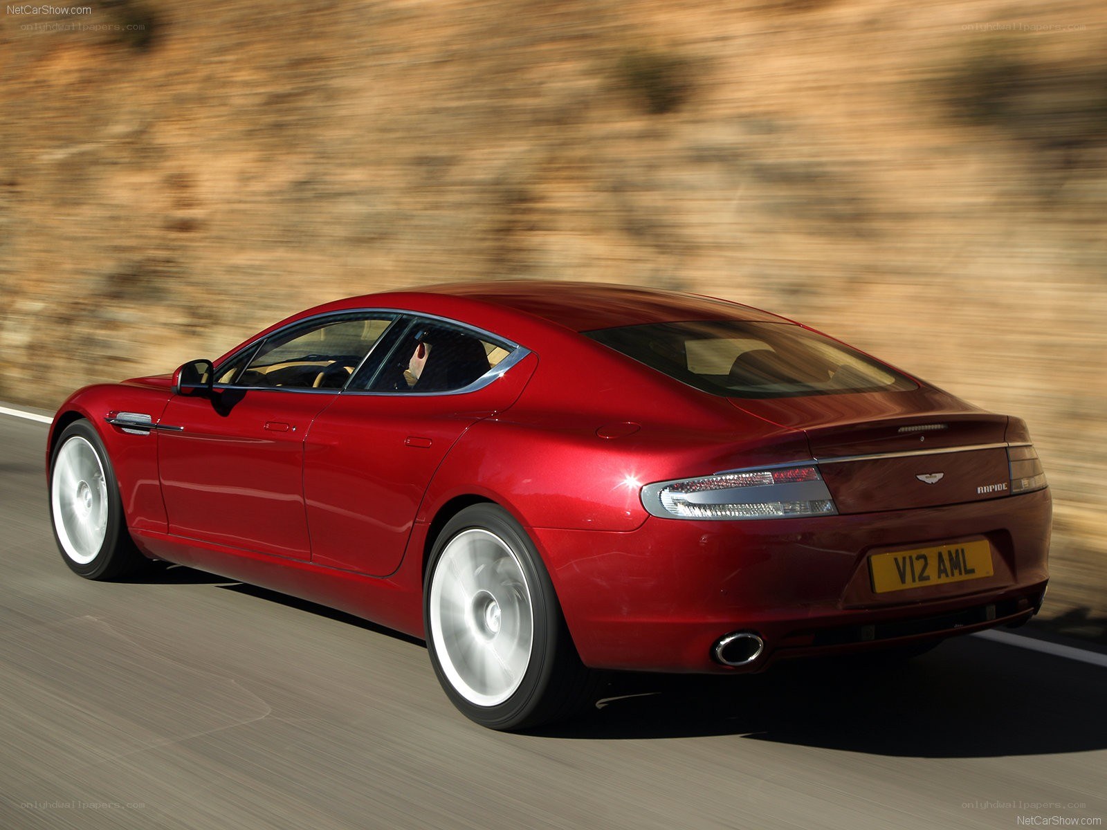 red aston martin rapier in motion
