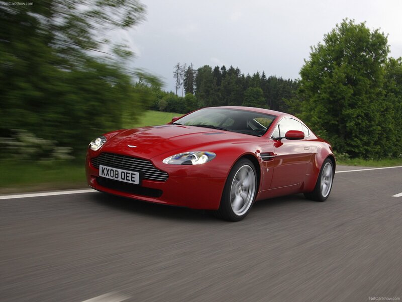 Red Aston Martin V8 on a country road