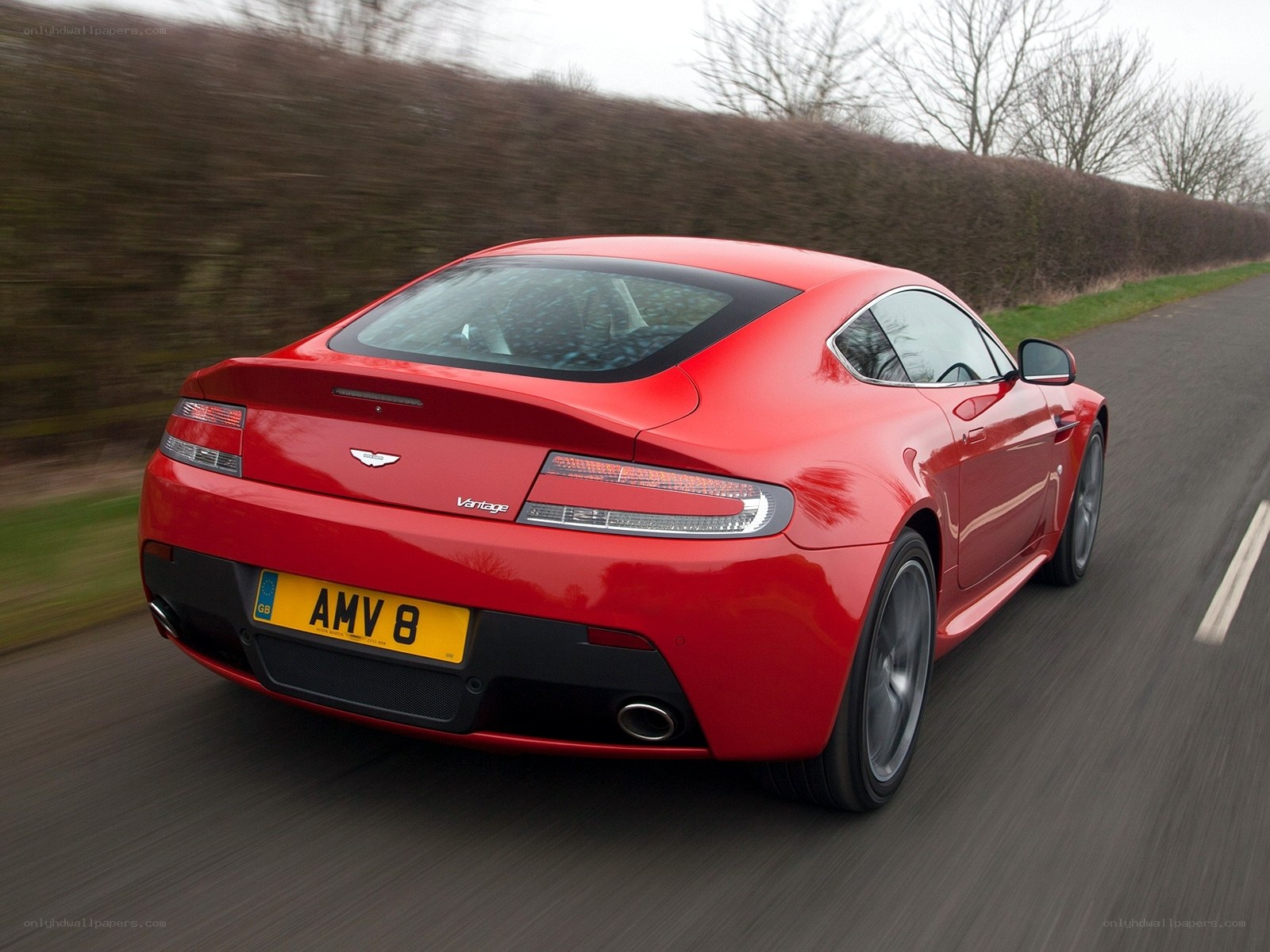 Red Aston Martin Vantage in motion