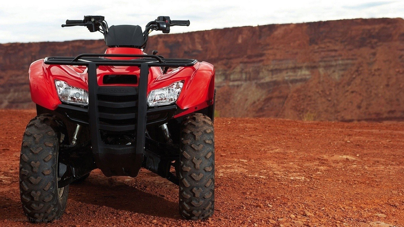 Red ATV in desert landscape