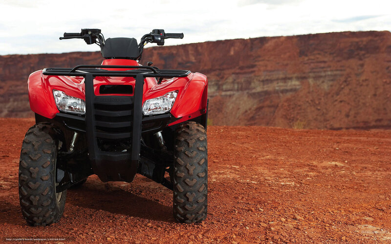 Red ATV in desert landscape