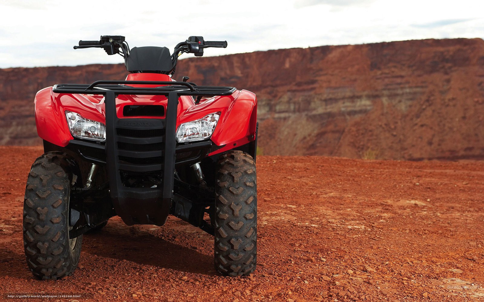 Red ATV in desert landscape