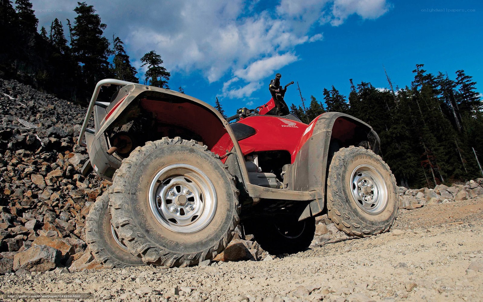 Red ATV on rocky terrain