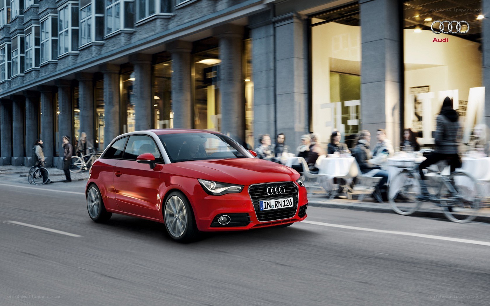 Red Audi A1 in city traffic