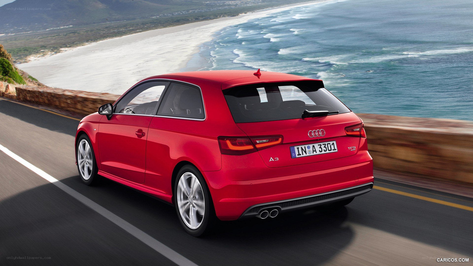 Red Audi A3 on coastal road