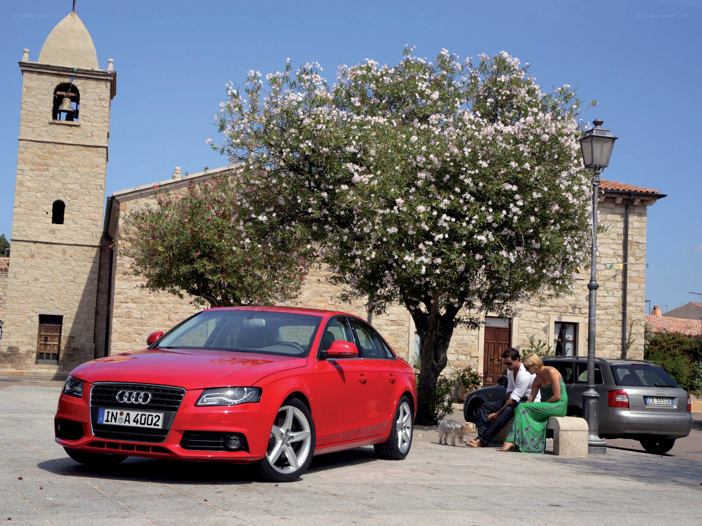 Red Audi A4 in a village square
