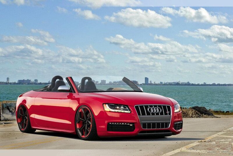 Red Audi convertible by the water