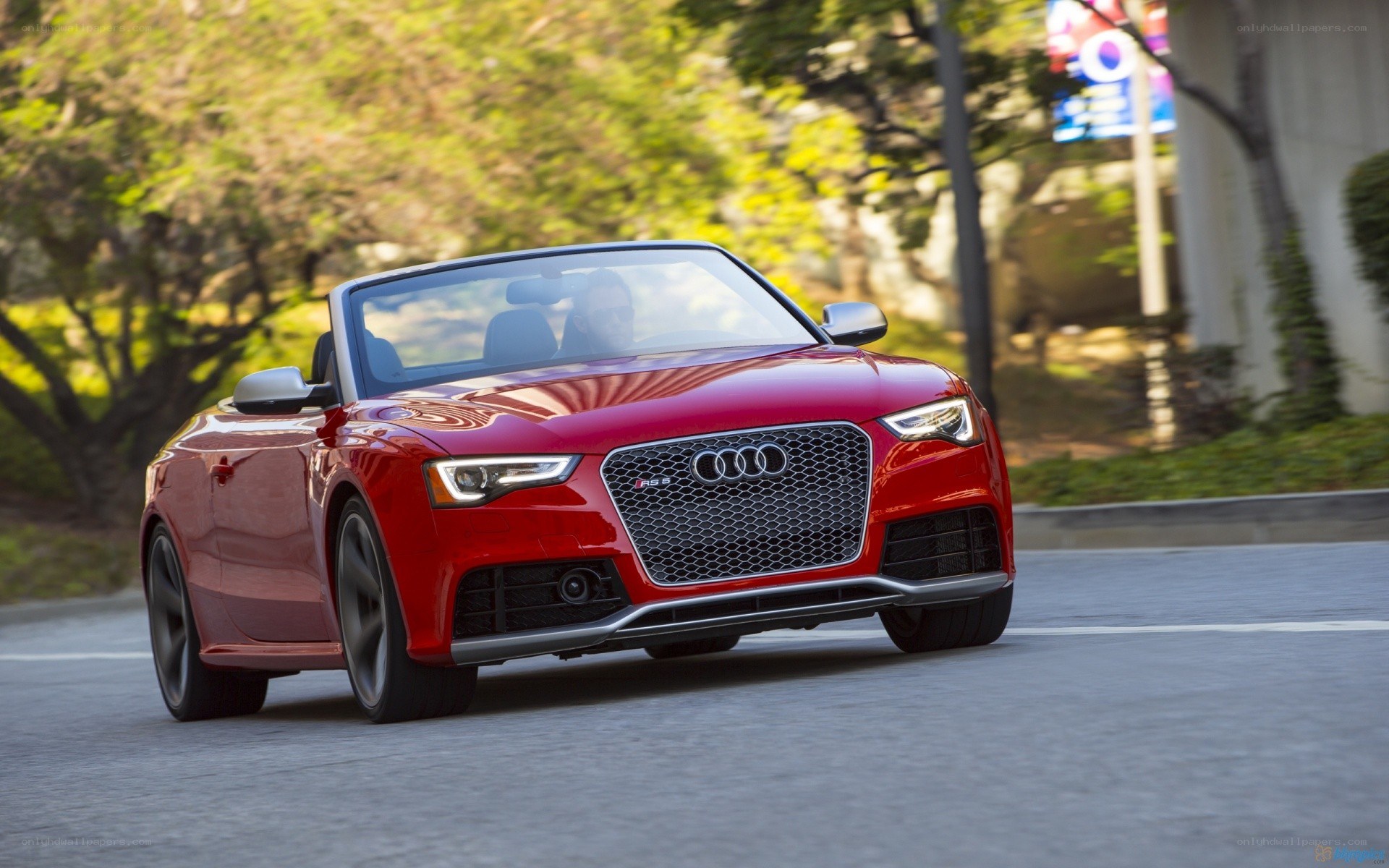 Red Audi convertible on road