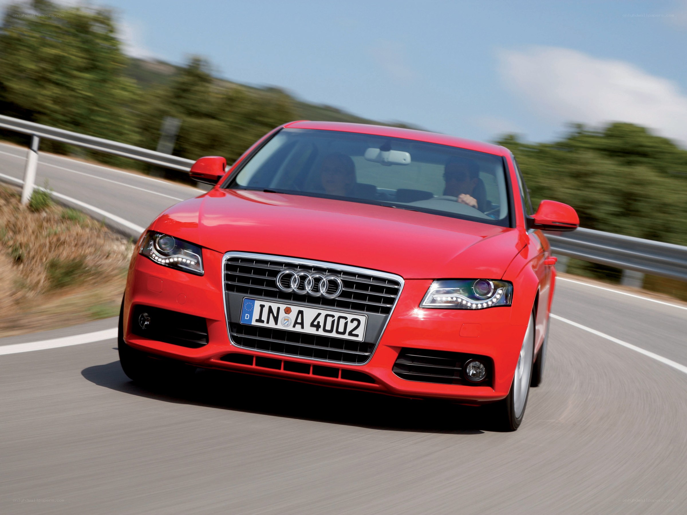 Red Audi driving on a road
