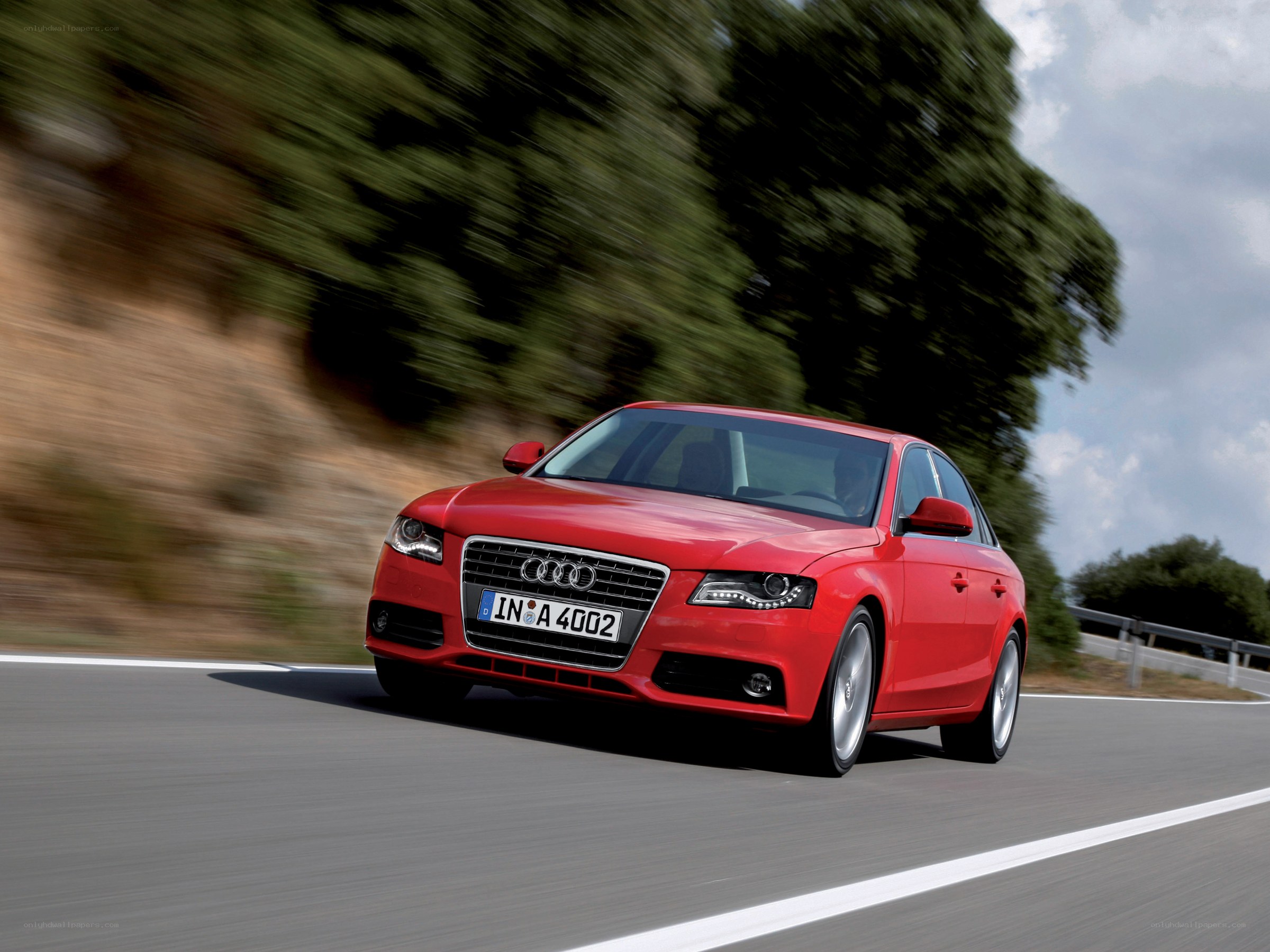 Red Audi driving on a road
