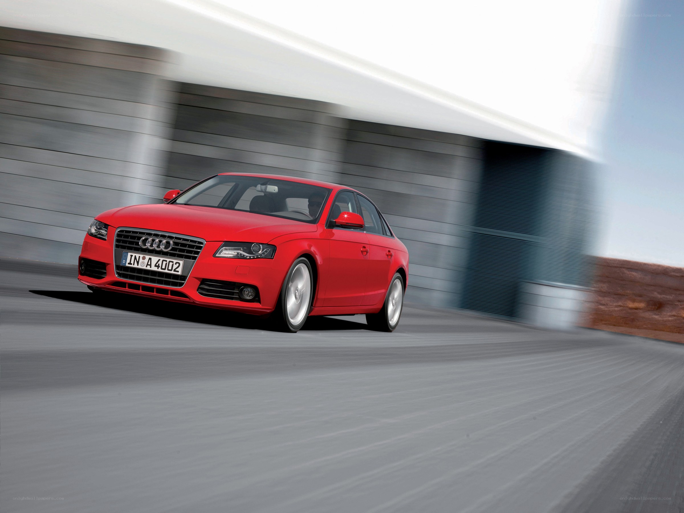 Red Audi driving on a road