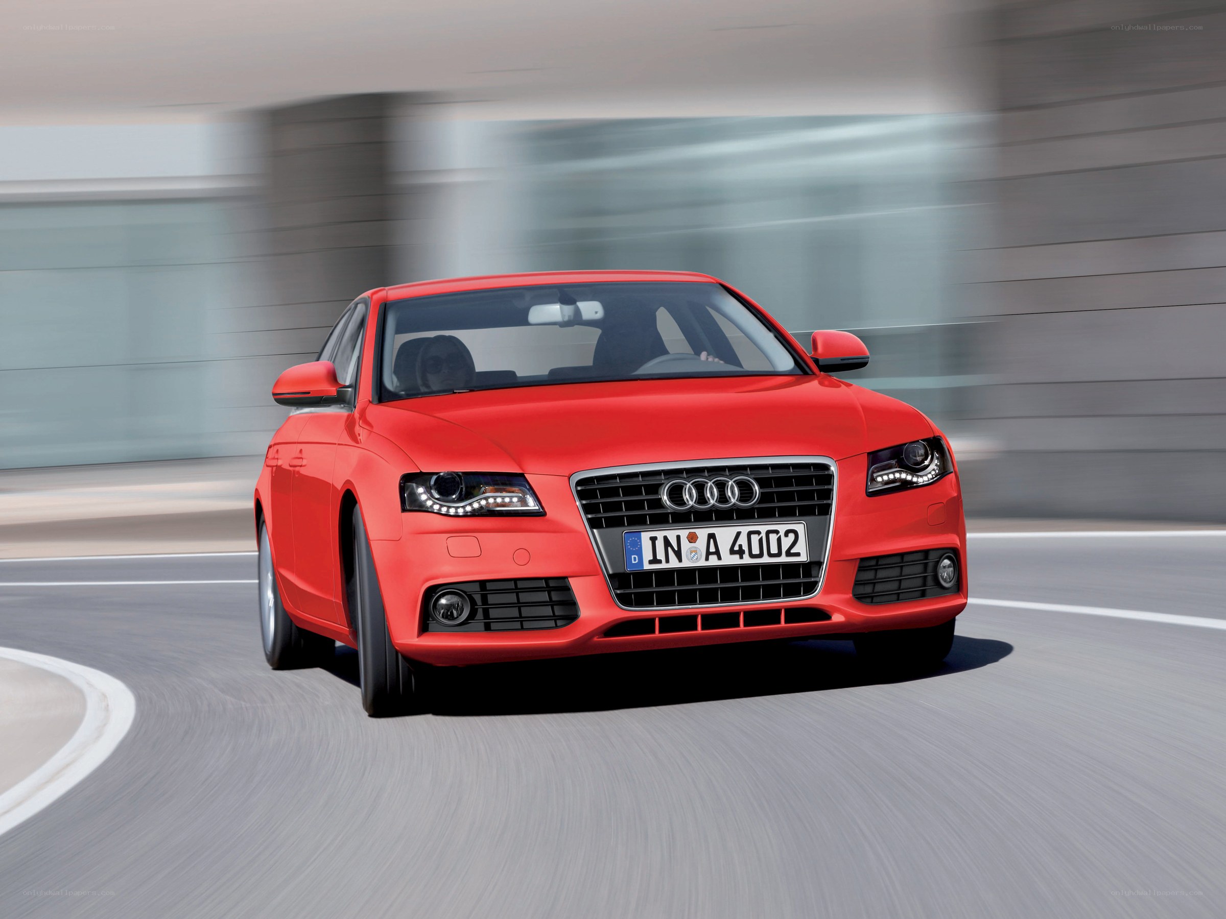 Red Audi driving on a road