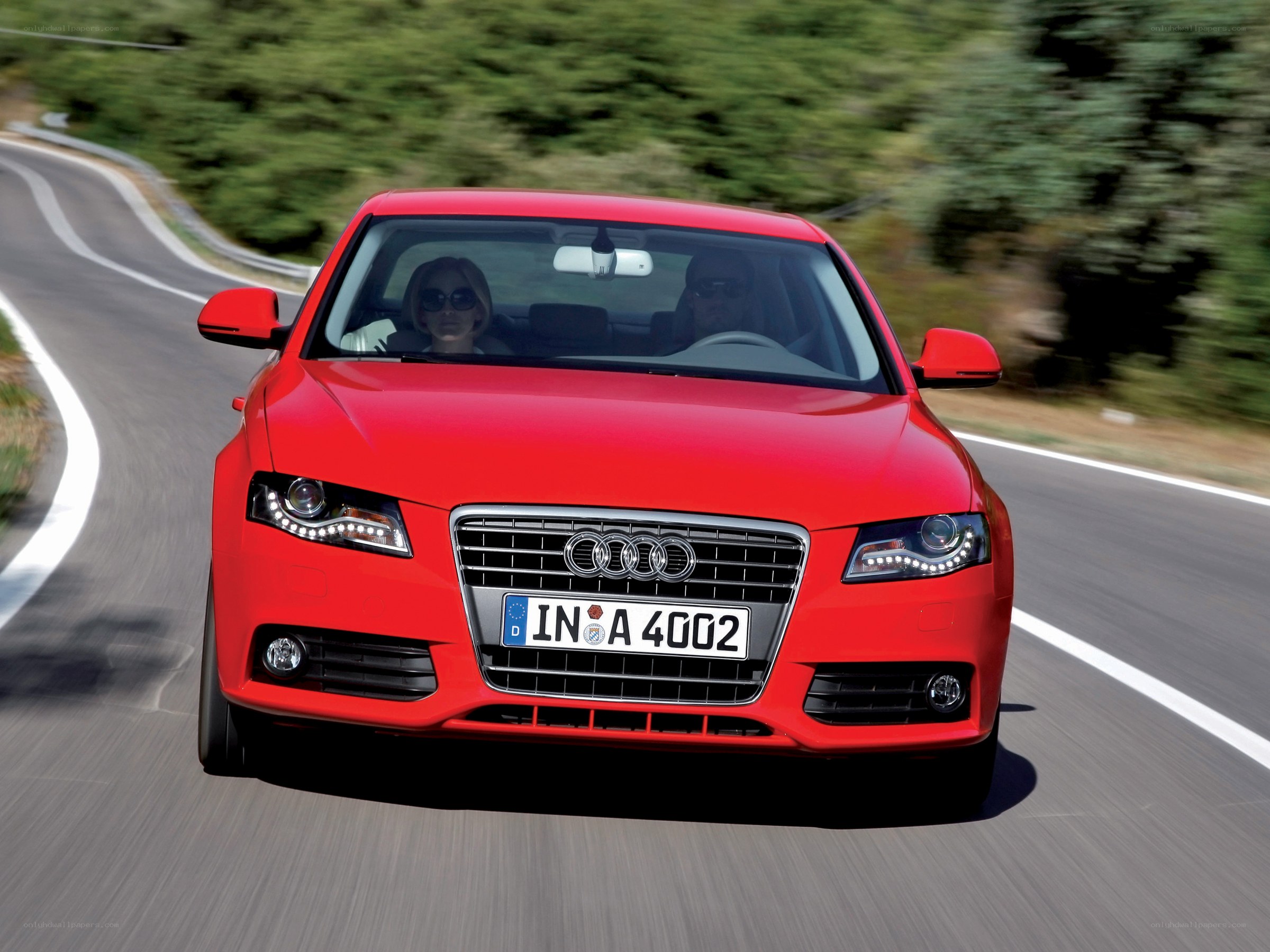Red Audi driving on a road