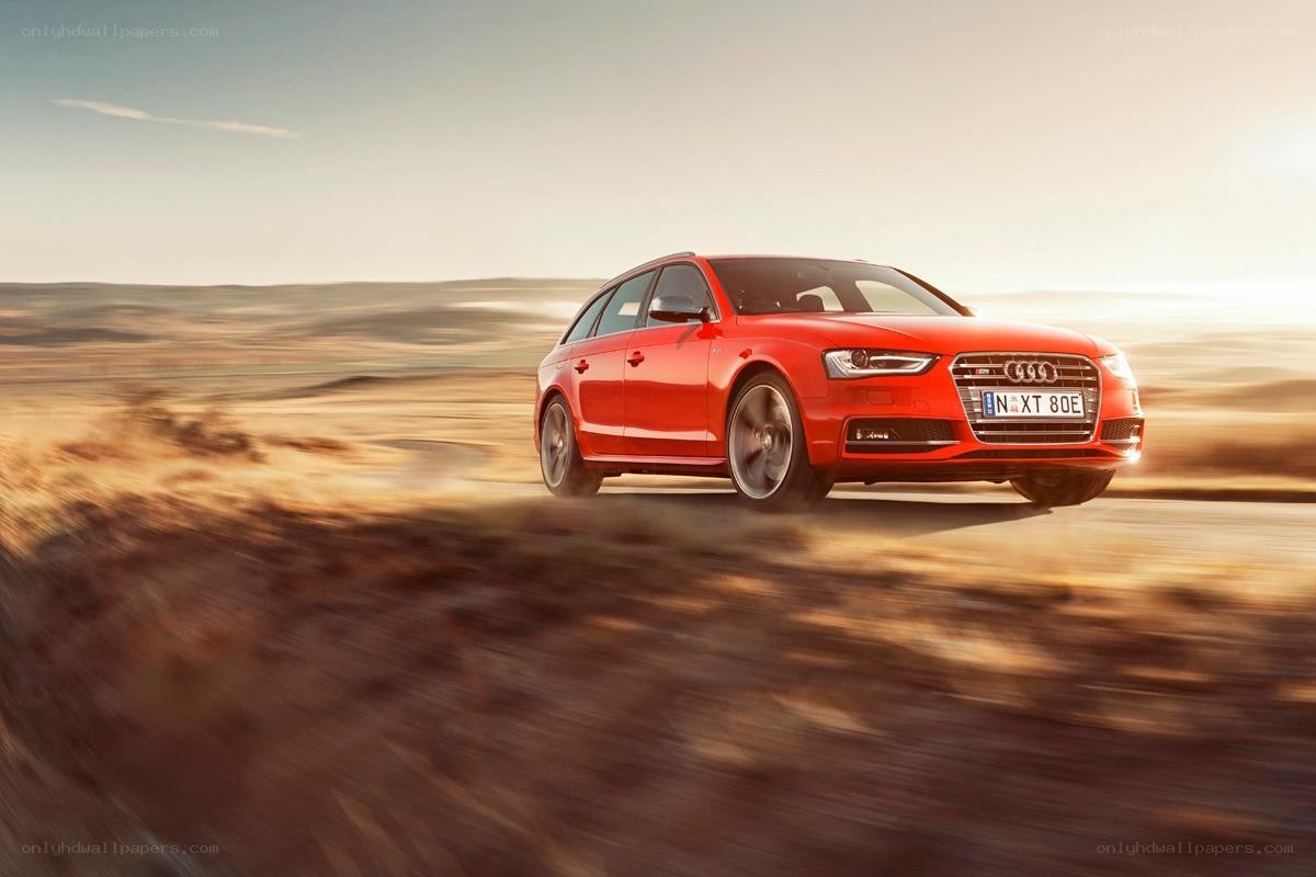 Red Audi driving on a road