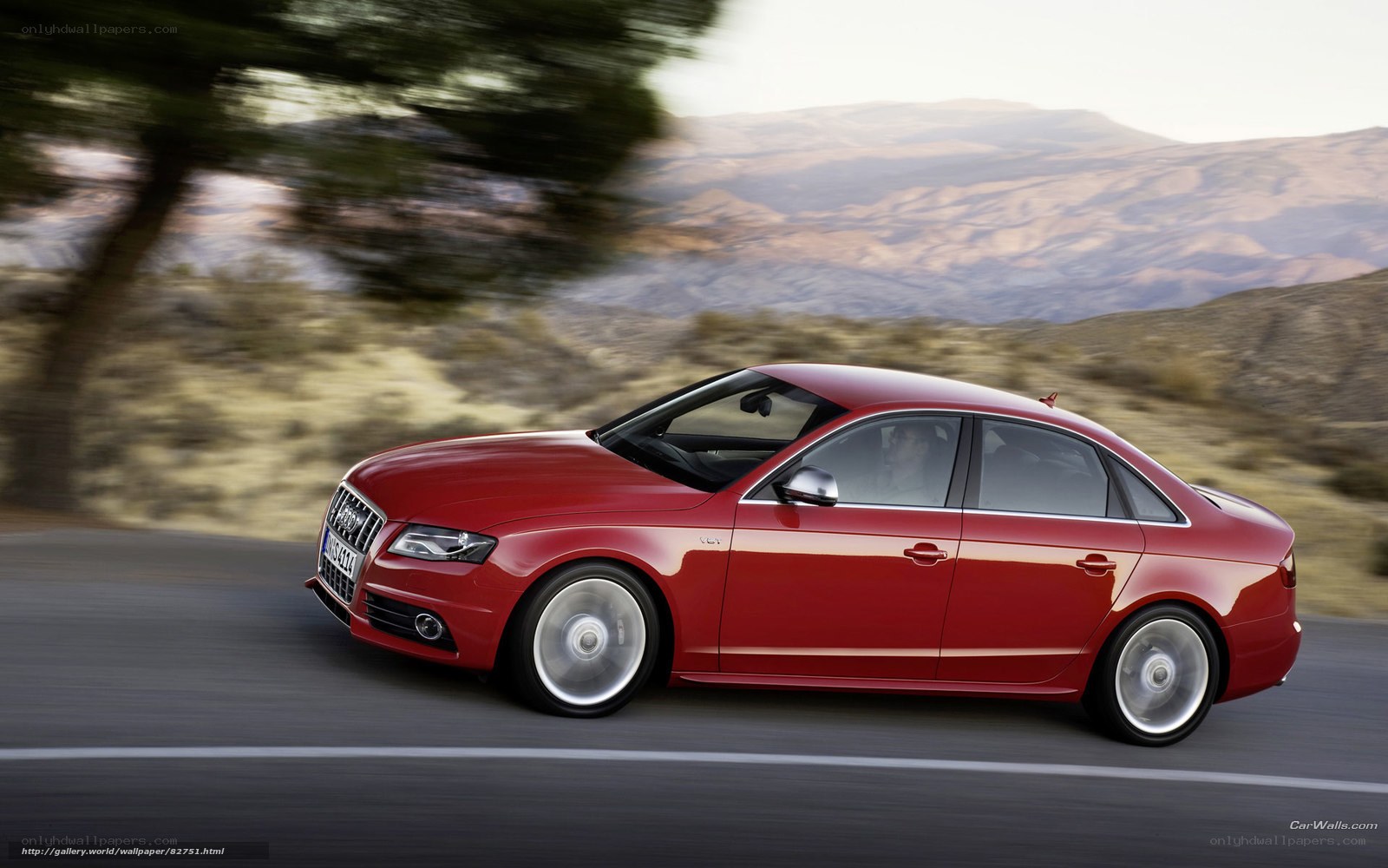 Red Audi driving on a road