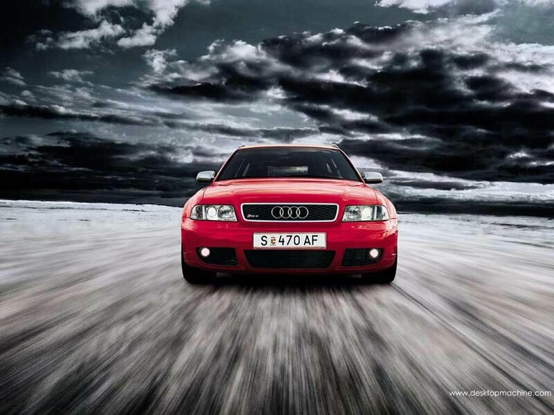 Red Audi driving on road