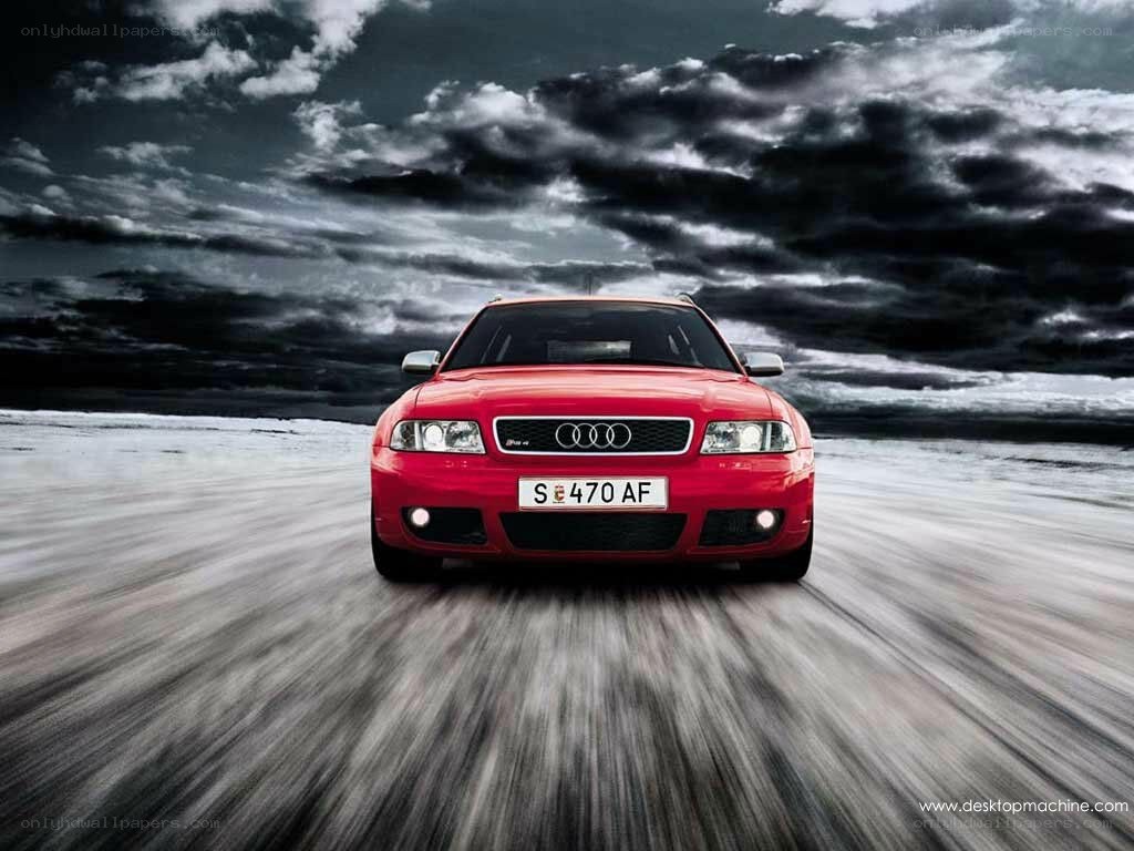 Red Audi driving on road