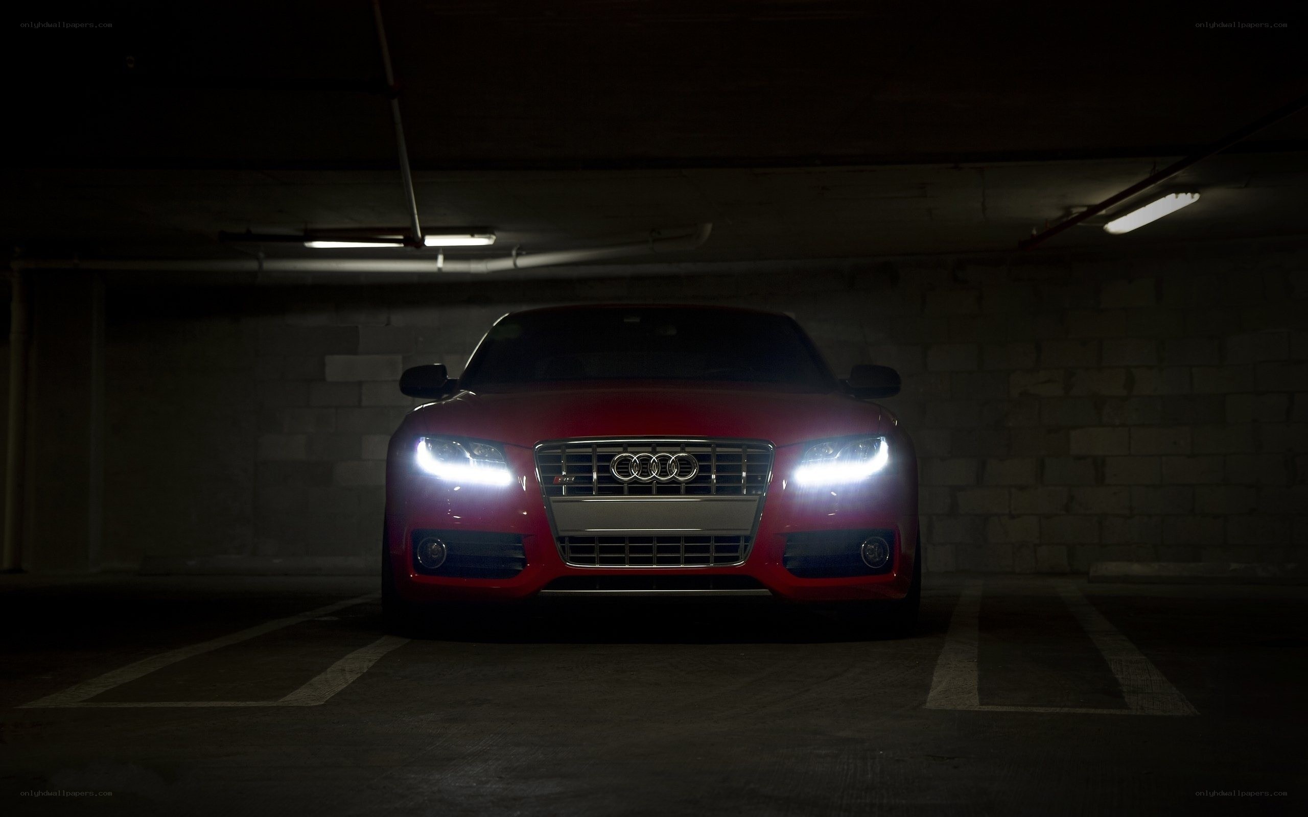 Red Audi in dark garage