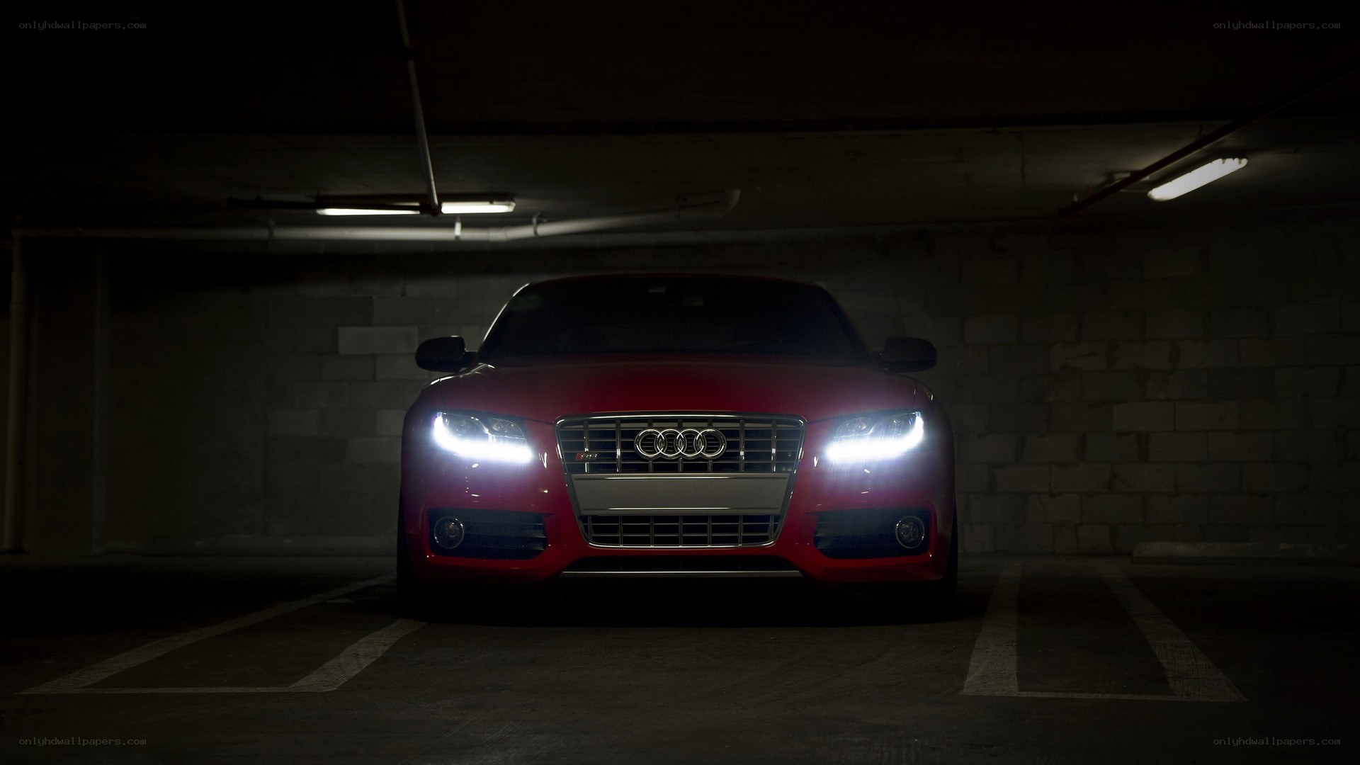 Red Audi in dark garage