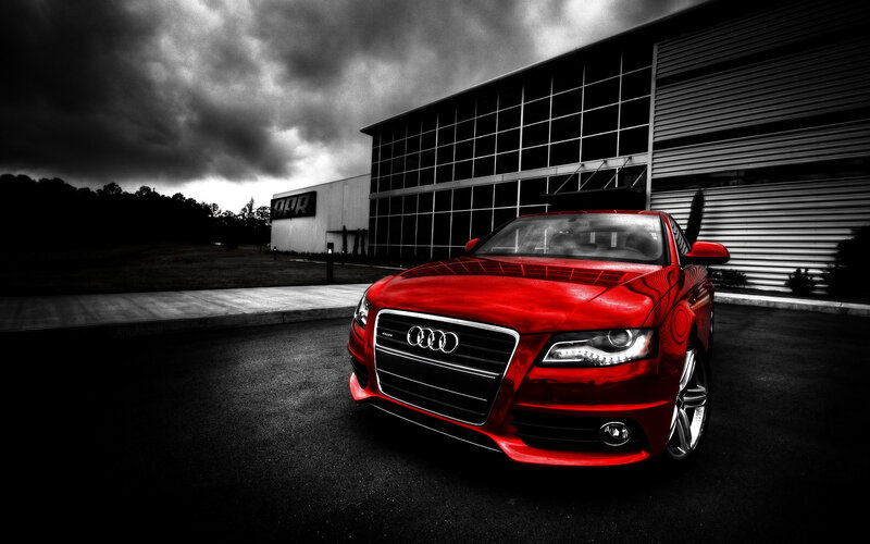 Red Audi in front of building