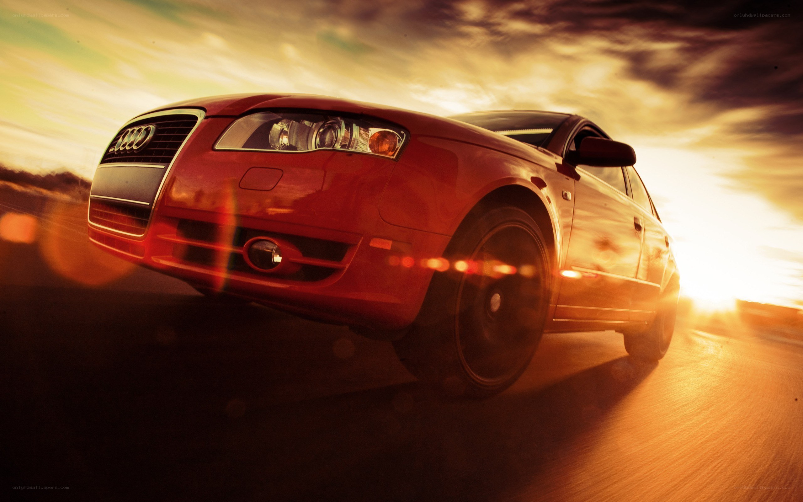 Red Audi in motion at sunset